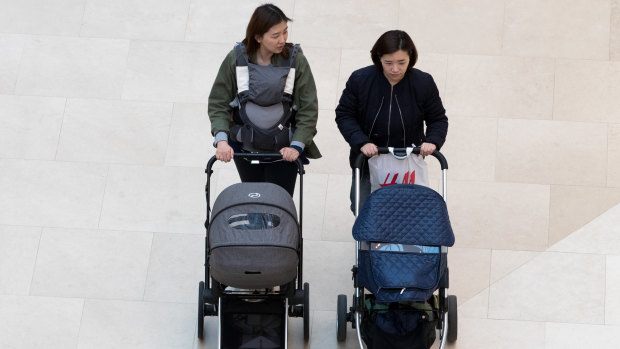 Two women push baby strollers in the Starfield Hanam shopping complex in Hanam, Gyeonggi, South Korea.