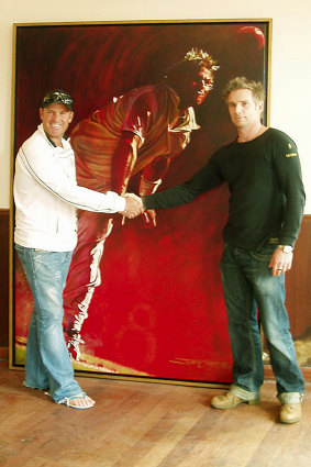 Artist Jamie Cooper posing with Shane Warne and his his first portrait of the late spinner.