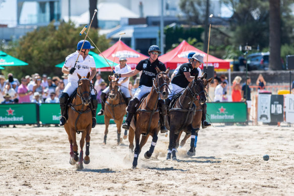 Polo players at Twilight Beach Polo at St Kilda on Saturday.