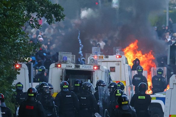Police attempt to disperse protesters near Newtownabbey, in Belfast.