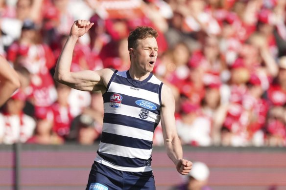 Mitch Duncan of the Cats celebrates after kicking a goal.