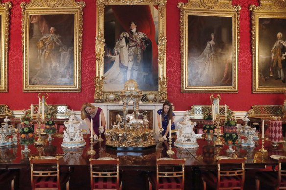 Pomp and ceremony: Buckingham Palace staff arrange a dining table as part of a 2019 exhibition.