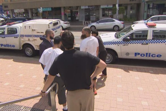 Six of the seven men arrested by police outside Liverpool Police Station after being released from custody.