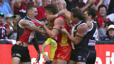 Saints and sinners: St Kilda's Matthew Parker (far left) tussles with Gold Coast's Charlie Ballard.