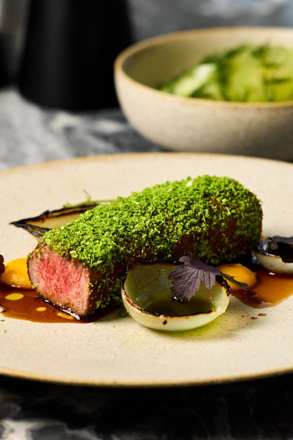 Herb-crusted Queensland lamb back strap with carrot puree, charred baby onions and lamb jus.