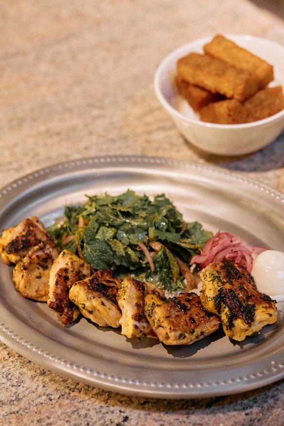 Fenugreek chicken thigh with soured onion, toum and fine herb salad.