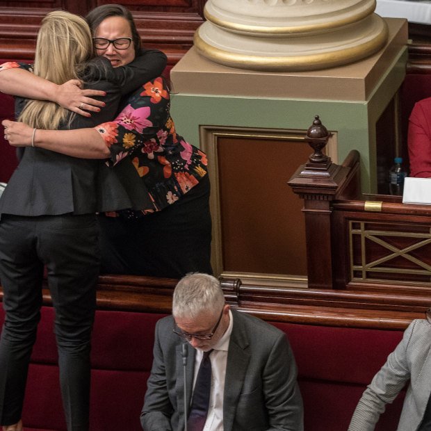 After a marathon 29 hours sitting to pass the Voluntary Assisted Dying Bill, Fiona Patten of the Reason Party stands on the seats to hug Labor’s Harriet Shing after the vote passes.   