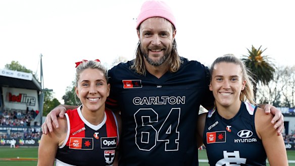 Mitch Brown with St Kilda’s Hannah Priest and Carlton’s Abbie McKay during the AFLW’s Pride Round.