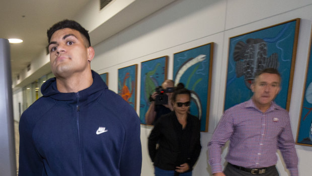 Broncos star David Fifita arrives at the Brisbane International Airport, accompanied by his mother and Broncos CEO Paul White, right. 