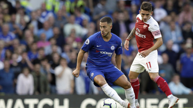 Staying put: Chelsea's Eden Hazard controls the ball in front of Arsenal's Lucas Torreira.