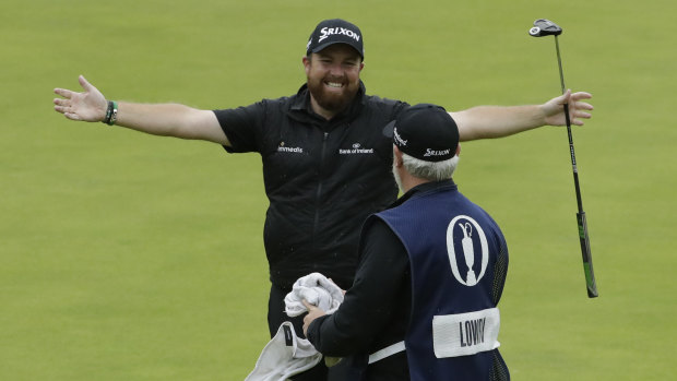 Ireland's Shane Lowry celebrates on the 18th green with his caddie Bo Martin after winning the British Open at Royal Portrush in Northern Ireland on Sunday.