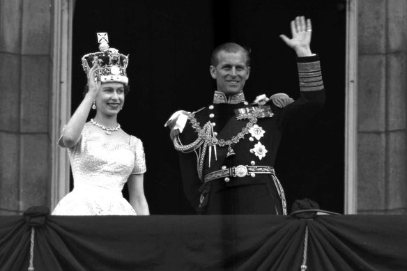 Queen Elizabeth II and Prince Philip, Duke of Edinburgh, wave to supporters from the balcony at Buckingham Palace following her coronation at Westminster Abbey, London. 