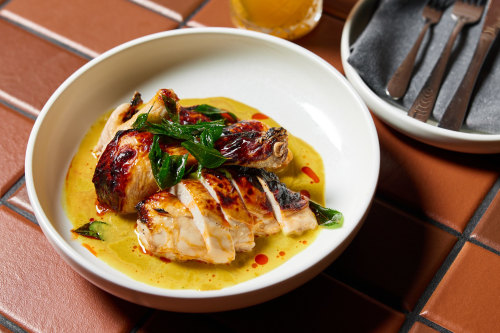 Monal Dining’s roasted chicken glazed with lemon molasses and finished with a curry sauce.