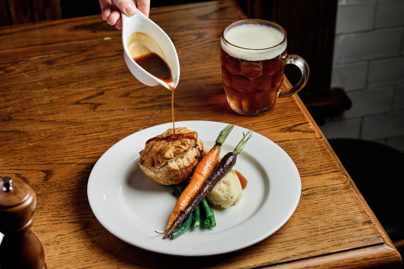 Braised steak and Guinness pie with mash and roasted vegetables.