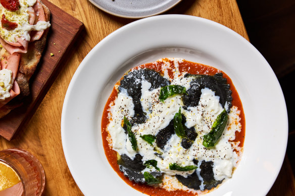 Squid ink baccala mantecato and potato ravioli with a puttanesca sauce and stracciatella.