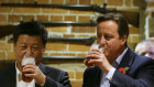 Better times. Xi Jinping and David Cameron down a pint near Chequers, England. 