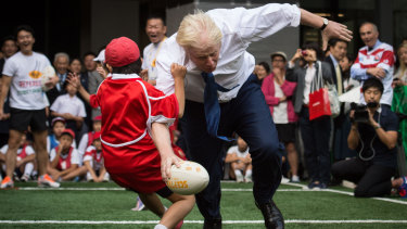 Boris Johnson supervised games of 'murderball' at Timbertop as a teachers' assistant. Here he shows his rugby form in Tokyo in 2015.