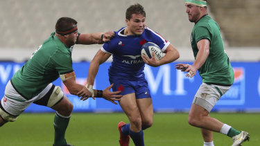 France's Antoine Dupont, centre is tackled by Ireland's CJ Stander, left, during the Six Nations rugby union international match between France and Ireland in Paris, France, Saturday, Oct. 31, 2020. 