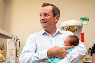 WA Premier Mark McGowan holds a bub as Labor reiterates its commitment on Sunday to building a new women’s and babies hospital.