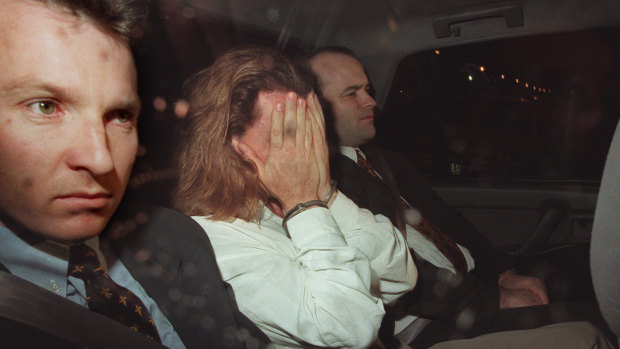 Extradited from Queensland  Shane Cogley arrives at the Melbourne Custody Centre in handcuffs with Vic police in 1997.