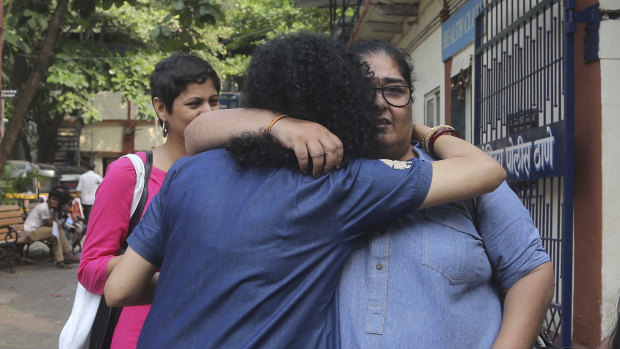 Former TV producer, director and writer Vinita Nanda, right, is greeted by a friend after filing a complaint against actor Alok Nath in Mumbai, India, on Wednesday. Encouraged by other women's testimonies of sexual misconduct, more Indian women are coming forward.
