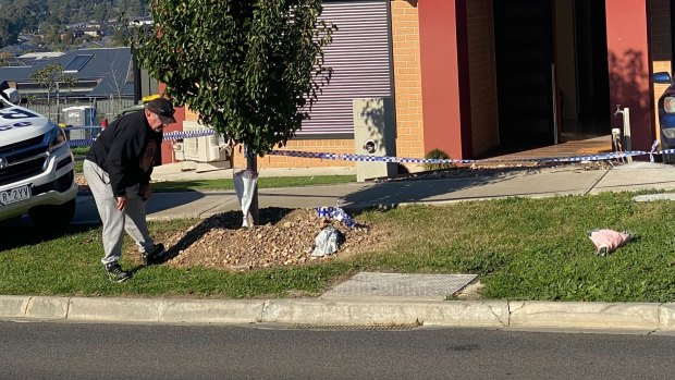 A neighbour laying flowers outside the home on Saturday morning.