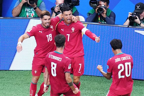 Portugal’s Cristiano Ronaldo celebrates with Pedro Neto, Bruno Fernandes and Joao Cancelo after scoring his side’s third goal.