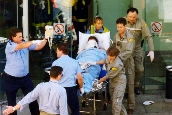 One of the victims of the National Crime Authority (NCA) bombing in March 1994 is wheeled away by emergency services.