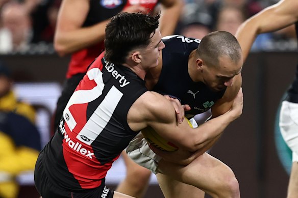 Francis Evans of the Blues is tackled by Archie Roberts of the Bombers.