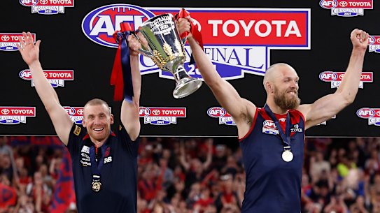 Melbourne coach Simon Goodwin and captain Max Gawn lift premiership cup.