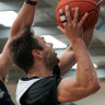 Melbourne United guard Matthew Dellavedova attempts a lay-up while being pressured by NBA forward Jack White at training on Wednesday.