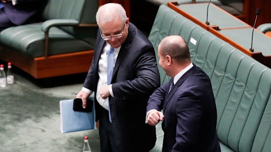 Prime Minister Scott Morrison and Treasurer Josh Frydenberg tap elbows in Parliament this week