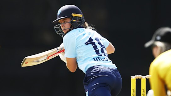 Phoebe Litchfield tucks a delivery away behind point during her century against WA.
