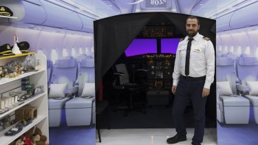 Ahmed Abdelwahed outside the flight simulator he has constructed in his EzyMart store on Elizabeth Street.