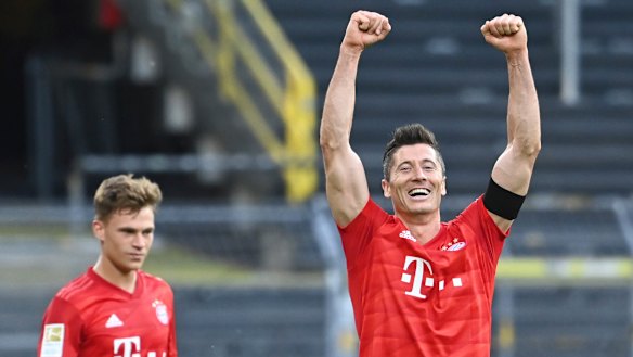 Kimmich, left, looks on as Bayern teammate Robert Lewandowski celebrates a goal likely to prove crucial in the Bundesliga title race.