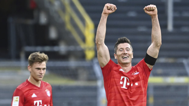 Kimmich, left, looks on as Bayern teammate Robert Lewandowski celebrates a goal likely to prove crucial in the Bundesliga title race.