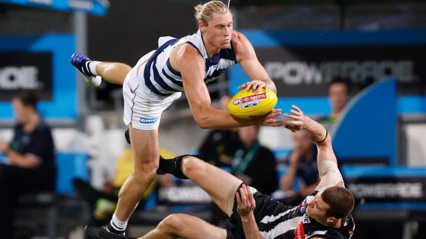 Rough and tumble: Mark Blicavs collides with Magpie Mason Cox during Geelong's emphatic semi-final win over Collingwood at The Gabba.