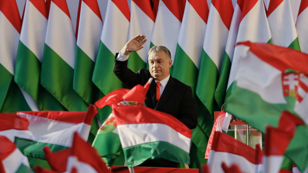 Hungarian Prime Minister Viktor Orban wraps himself in the flag on his way to three successive terms.