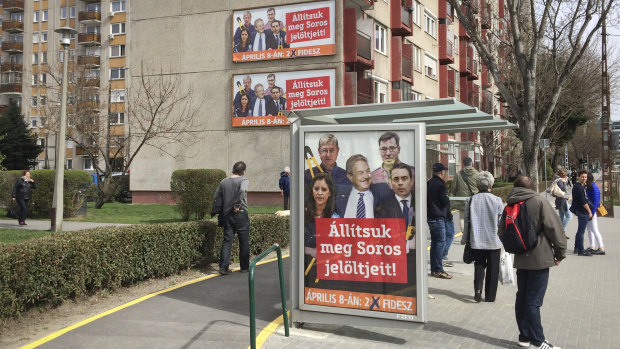 Billboards from Prime Minister Viktor Orban's Fidesz party reads "Together they would dismantle the border seal." showing American financier George Soros, center, with opposition leaders, in Budapest.