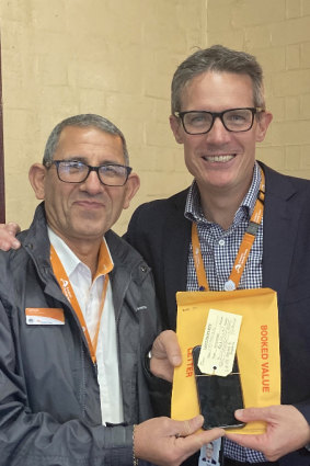 About 50,000 items are lost on Sydney trains every year. Station duty manager Safwat Mena (left) reunites Sydney Trains chief executive Matt Longland with his lost phone.