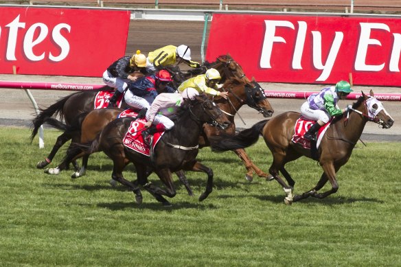 Michael Walker, in the yellow silks, rides Criterion to third in the 2015 Melbourne Cup behind Prince Of Penzance.