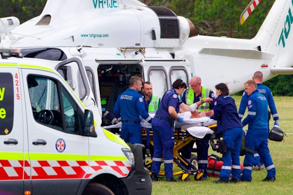 Paramedics prepare to transport the injured by helicopter.