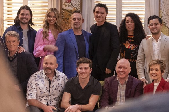 Neighbours cast members, including long-time stars Stefan Dennis, Ryan Moloney, Alan Fletcher and Jackie Woodburne (front row) pose for a photo.