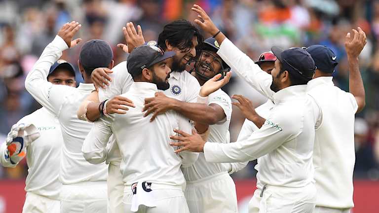 India celebrate their victory in Melbourne.