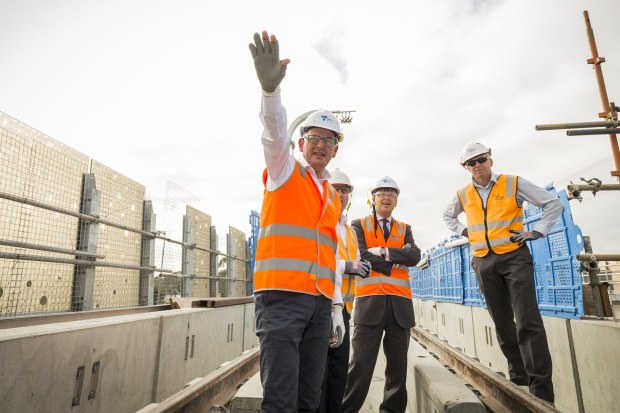 Andrews visits the partly constructed Noble Park "sky rail" overpass in 2018. Tackling the traffic bottlenecks created by rail-and-road intersections this way has been popular with the electorate.  