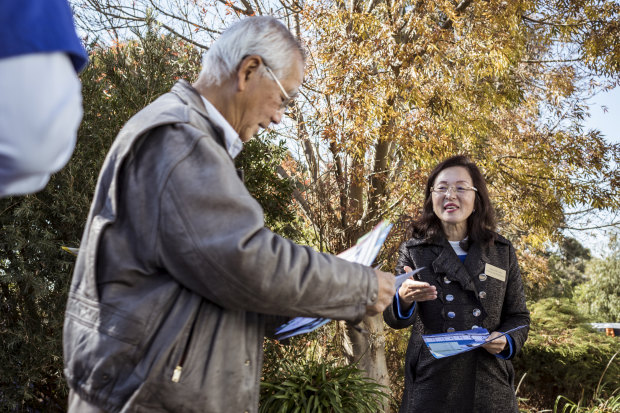 Gladys Liu greets a voter on election day in 2019, having worked polling stations assiduously for weeks.