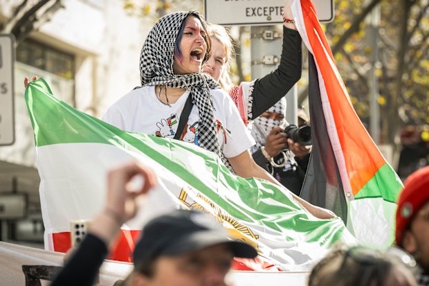 Protesters carrying Palestinian and Iranian flags at a rally in June last year.