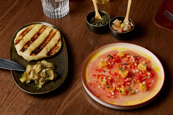 Chapa flatbread served with pickled cucumber and tuna carpaccio with charred mandarin and a sweet pepper escabeche.