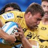 Nick Champion de Crespigny of the Force is tackled against the Waratahs.
