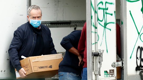 Labor MP Bill Shorten delivers food to the Flemington Towers Government Housing complex.